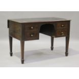 An early 19th century walnut and mahogany kneehole writing desk, the top inset with a leatherette
