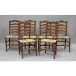 A set of six early 19th century provincial fruitwood ladder back kitchen chairs, height 95cm,