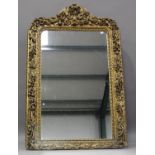 A mid-19th century carved giltwood and gesso framed pier mirror, profusely carved with leaf, fruit