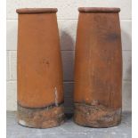 A pair of terracotta chimneys, height 77cm, diameter 30cm.Buyer’s Premium 29.4% (including VAT @