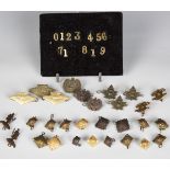 A large collection of early 20th century military cap badges and insignia, mainly New Zealand and