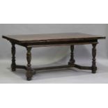 A 20th century oak draw-leaf dining table with parquetry top, on turned baluster legs, height