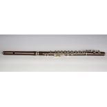 A late 19th century rosewood flute with nickel keywork, cased (thin hairline crack to one section).