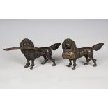 A pair of late 19th/early 20th century Austrian cast bronze models of poodles, one holding a