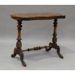 A mid Victorian burr walnut centre table, the shaped top raised on turned and fluted supports, on