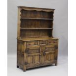 A 20th century Jacobean style oak dresser, the shelf back above three drawers and a cupboard, height