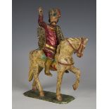 A 19th century Continental carved and painted wooden figure of a soldier on horseback, height 26cm.