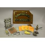 A group of chocolate making items, including moulds, presses and instruction books, and a glass