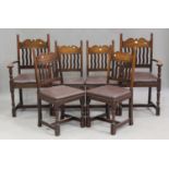 A set of six mid-20th century Arts and Crafts style oak dining chairs with shaped bar and wavy