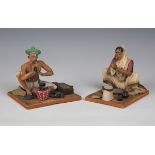 Two 20th century Indian clay figures of a seated man and woman, height 13cm, together with a painted