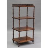 A Victorian mahogany four-tier whatnot with pierced gallery top, raised on bobbin turned supports,