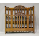 An Edwardian walnut double bed frame with carved foliate decoration, height 130cm, length 195cm,