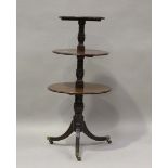 A late 19th/early 20th century mahogany three-tier dumb waiter with drop flaps and sabre legs,