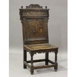 A 17th century oak Wainscot side chair, the panelled back with floral marquetry above a panelled