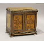 An Edwardian figured mahogany parquetry veneered table-top cabinet, fitted with slides and