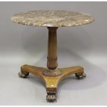 A Regency style mahogany marble-topped circular centre table, raised on a floral cusp stem and