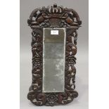 A Charles II and later walnut framed mirror, the crest carved with putti and crown, 55cm x 28cm (