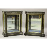 A pair of late 19th century ebonized and parcel gilded pier cabinets with inlaid bone decoration,