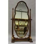 A mid-19th century walnut framed full-length cheval mirror, the shaped plate on tapering supports