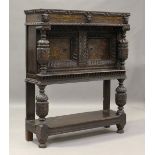 An 18th century and later oak and floral marquetry side cabinet, profusely carved with foliate