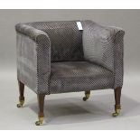 An Edwardian tub back salon chair, upholstered in grey patterned fabric, raised on square tapering