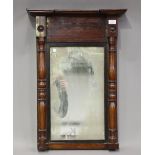 A Regency figured mahogany pier mirror with turned pilasters, 73cm x 52cm.Buyer’s Premium 29.4% (
