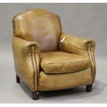A 20th century French brown leather club armchair with studded borders and turned feet, height 90cm,