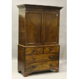 An early Victorian mahogany linen press, fitted with two panelled doors above drawers, height 217cm,