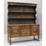 A George V oak dresser, the shelf back above two drawers flanked by cupboards, height 206cm, width