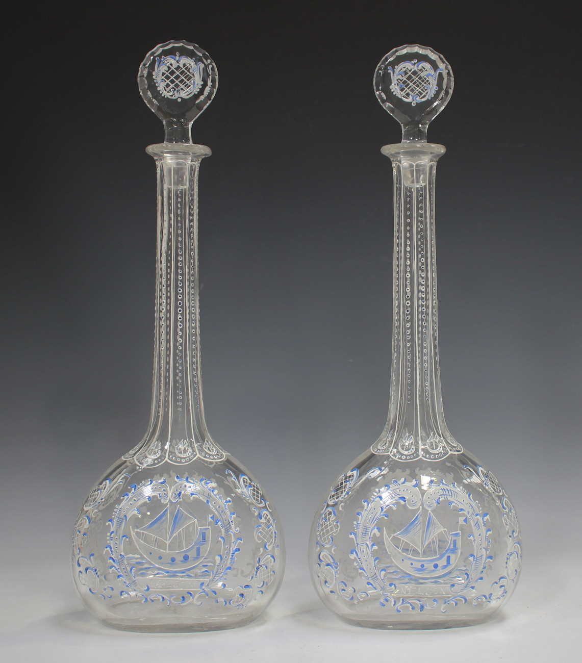 A pair of enamelled glass decanters and stoppers, 19th century, in Beilby style, each flattened