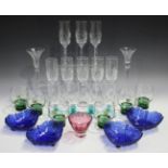 A group of decorative glassware, including a set of four wine glasses, each with a different