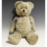 A mid-20th century Schuco mohair teddy bear with black and white eyes, stitched snout and jointed