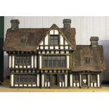 A Robert Stubbs 1/12th scale Lea House doll's house with thatched effect roof, removable roof and