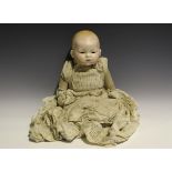 An Armand Marseille bisque head baby doll with painted hair and features and fabric body, height