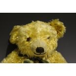 A Merrythought mohair teddy bear with large flat ears, amber and black eyes, stitched snout and