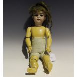 A Schoenau and Hoffmeister bisque head doll, impressed 'SH 1079 DEP', with brown wig, fixed brown