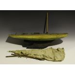 An early/mid-20th century wooden pond yacht with cloth sails, faux wooden deck, cream and green