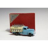 A French Dinky Toys No. 25-0 milk truck, finished with blue cab, cream body and black ridged wheels,
