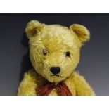 A mid-20th century Chiltern Hug Me mohair teddy bear with amber and black eyes, stitched snout and