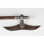 A 19th century Middle Eastern steel headed and white metal mounted battle axe, mounted on a hardwood