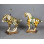 A pair of 20th century Tang style glazed pottery models of horses, mounted as table lamps and raised