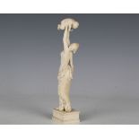 A 19th century ivory full-length figure of a classical maiden holding an infant boy aloft,