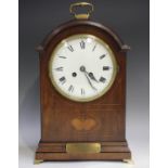 An Edwardian mahogany mantel clock with eight day movement striking on a gong, the white enamel