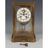 A late 19th century French brass four glass mantel clock with eight day movement striking on a gong,