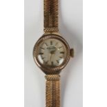 An Enicar 9ct gold lady's bracelet wristwatch, the signed circular silvered dial with gilt baton