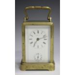 A late 19th century French brass one-piece cased carriage alarm clock with eight day movement