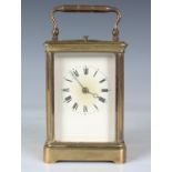 A late 19th century/early 20th century French brass cased carriage clock with eight day movement