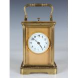 A late 19th century/early 20th century lacquered brass carriage clock with eight day movement