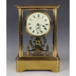 An early 20th century lacquered brass four glass electric mantel clock by Eureka Clock Co Ltd