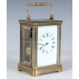 A late 19th century brass cased carriage clock with eight day movement striking hours and half hours